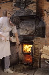 Baker preparing the oven for leather bread