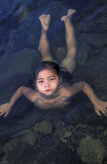 Kampot  a girl swimming in the Tek Chhou river rapids