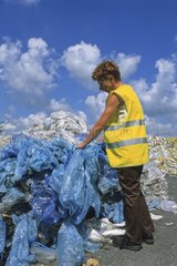 Arbeiter mit gepacktem Haufen Plastiktüten