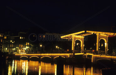 Life in Holland Netherlands night time exposure of the Skinny Bridge in Amsterdam Holland