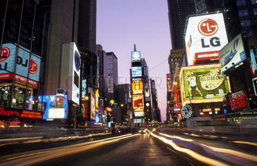 The beauty color and energy of famous Times Square at night with streaks of traffic in New York City USA