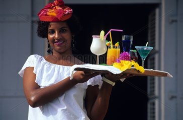 Portrait of a young woman carrying cocktails in Martinique