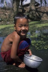 Child washing himself in a river Area of the lake Inle Myanmar