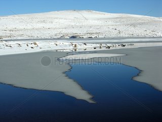Monks lake frozen in winter Aubrac France