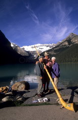 Lake Louise Banff canada beautiful lake with Swiss Alphorn player with tourists