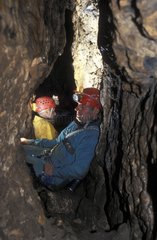 Two speleologists resting between two walls Hérault