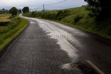 Campaign road wet after rain France
