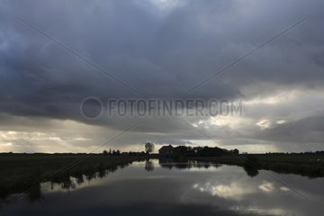 Cloudy sky above a channel Weerribben NP Netherlands