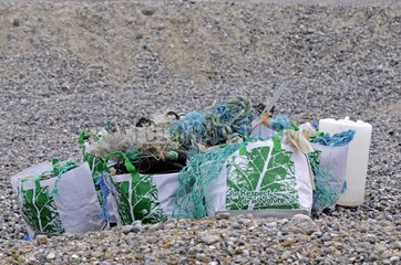 Bags of non-degradable garbage on a beach pebbles