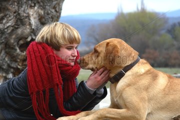 Young woman caressing a dog