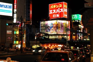 Tokyo at night with its neon signs and taxi