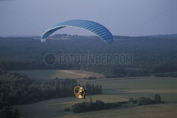 Air photograph of a U.L.M flying in skirt of forest