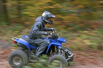 Man moving in quad in a forest