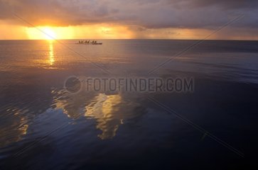 Dugouts on the lagoon at sunset Tuamotu Polynesia