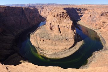 Horseshoe Bend  meandering the Colorado River  south of Page City  upstream is the site of the Glen Canyon Dam  whose construction has had the effect of creating the famous Lake Powell  Arizona  USA