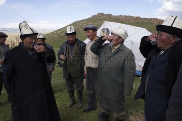 Group of Nomads drinking vodka in Kyrgyzstan