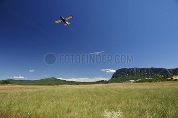 Propeller plane towing a glider to the Pic Saint-Loup