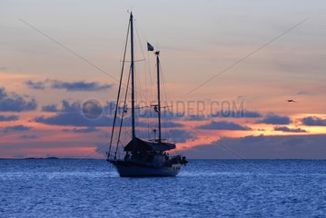 Sailboat at sunset in the archipelago of Los Roques