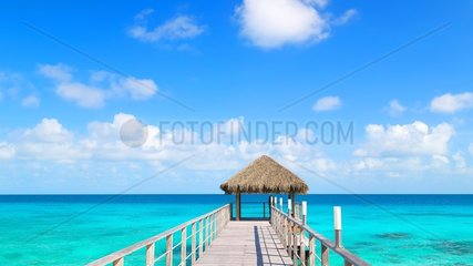 Fare at the end of a pontoon and turquoise sea  Rangiroa  French Polynesia