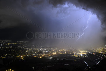 Eclair in the rain curtain of a storm above the town of Annemasse  Haute-Savoie  France. Shooting of June 14  2017.