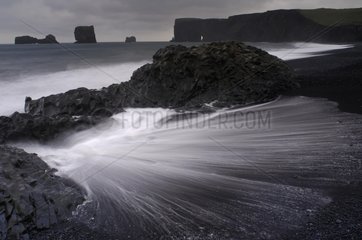 Black sand beach and volcanic rocks Dyrholaey Iceland
