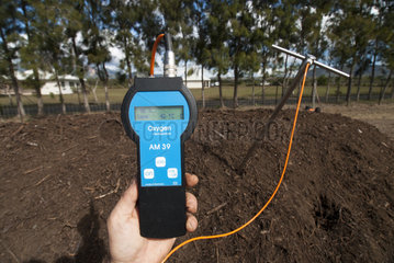 Measuring the temperature of a compost pile  New Caledonia.