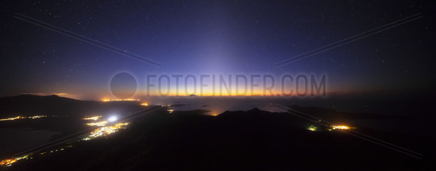 Panorama one hour before sunrise on Mount Choungui. The glow of the sun still behind the horizon gradually covers the glow of the stars. Mayotte