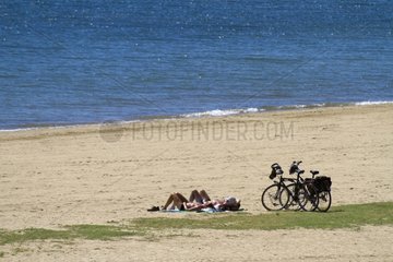 Cyclists resting on the beach of Miramar in the Var