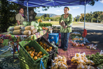 Kanak women selling fruits and vegetables on the roadside  New Caledonia