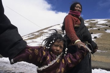 Young Tibetan girl with her mother and her grandmother Serxu