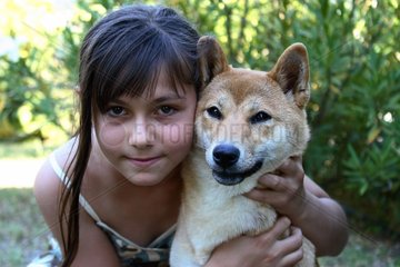 Portrait of a young girl and a Shiba Inu France