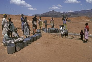 Villagers at water pump and new borehole Malawi