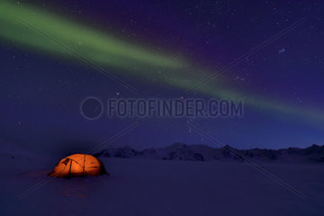 Aurora borealis on a bivouac on the Kolding Fjord. North East coast of Greenland