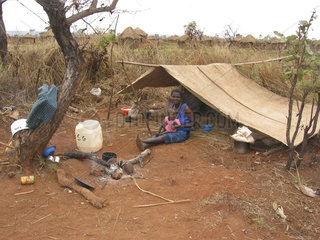 Woman and baby in a makeshift tent. Feeding centres and other humanitarian aid were organised in Angola after widescale malnutrition during and following the countrys civil war.