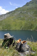 Accessories hiker in front of a mountain lake France