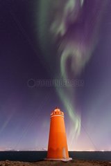 Aurora borealis and headlight Keflavik - Iceland