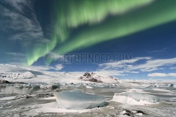 Aurora borealis on glacial lake in winter - Iceland