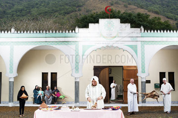Descendants of Algerian convicts preparing a meal in front of a mosque. New Caledonia