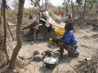 A family camps in the fields. Feeding centres and other humanitarian aid were organised in Angola after widescale malnutrition during and following the countrys civil war.