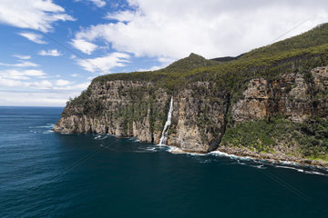 Waterfall jumping into the sea  Tasman National Park  Tasmania