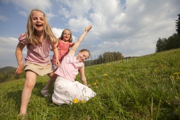 Young girls playing in a meadow in spring - Alsace France
