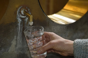 Filling of a glass of water  the refreshment bar  Source des Savonneuses  the National bath  thermal establishment built in 1811 and restored in 1935  Plombieres les Bains  Vosges  France