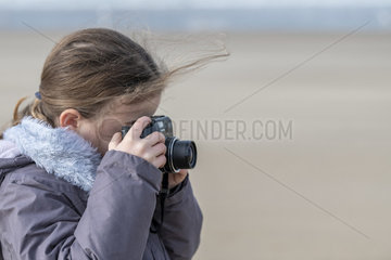 Girl taking a picture in winter  France