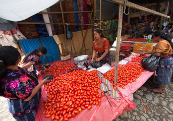 Guatamala ((maya) market vendors selling tomatoes