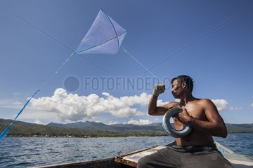 Man fishing with kite - Pantar island Alor Indonesia