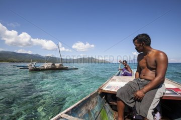 Fisherman putting traditional fish trap - Indonesia