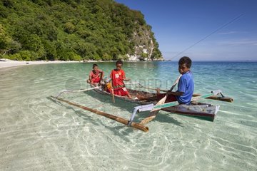 Chidren in a traditional boat - Batu Putih Alor Indonesia