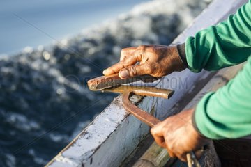 Fisherman sharpening harpoon for manta ray - Solor Indonesia