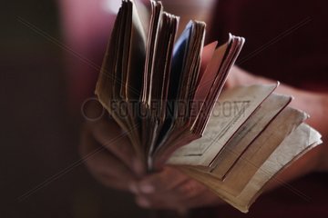 Prayer book in the hands of a Buddhist monk India