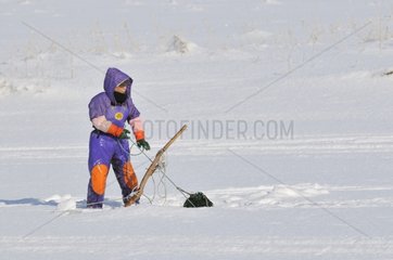 Fisherman doing hole fishing on the frozen Furen Lake Japan
